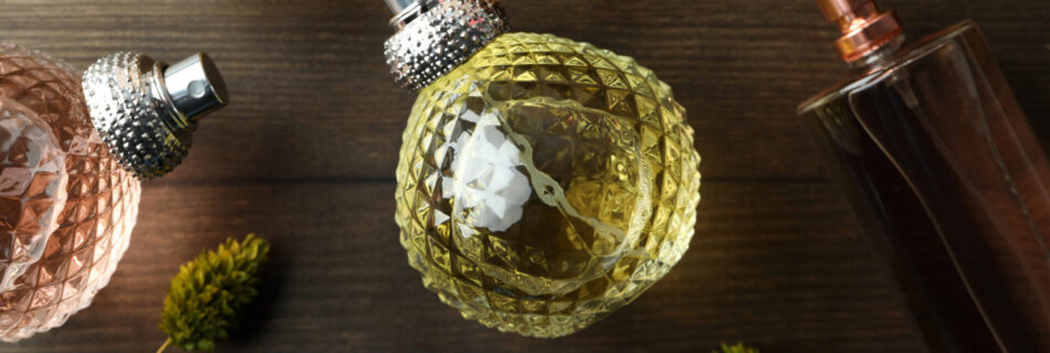 bottles of perfumes on wooden background top view 2023 11 27 05 15 38 utc scaled