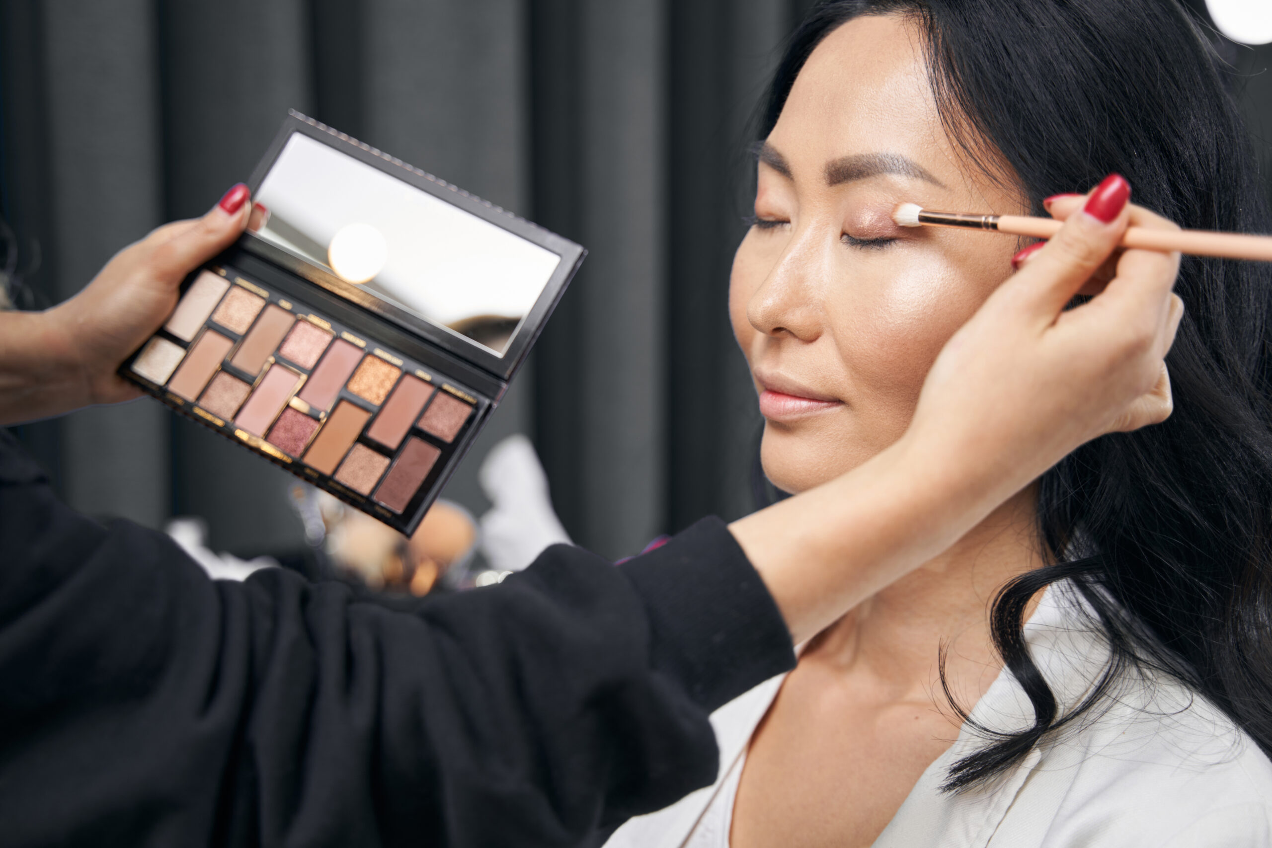 unrecognized makeup artist doing makeup with set o 2024 10 18 08 35 49 utc 1 scaled