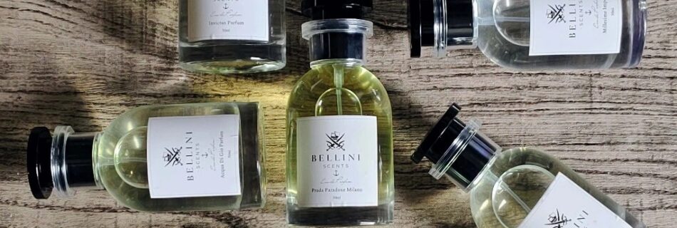 A imagem mostra seis frascos de perfumes Bellini Scents, em um fundo amadeirado